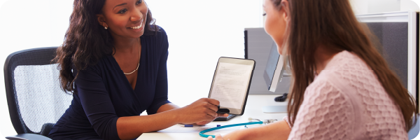 a female doctor and female patient having consultation in doctors office to signify IBS diagnosis