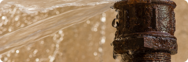 A rusty leaky pipe to illustrate intestinal permeability, known as "leaky" gut.