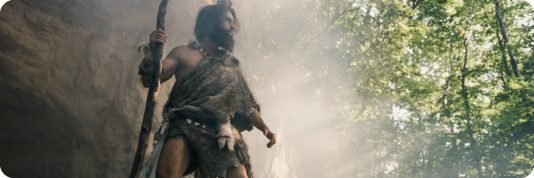 a caveman standing in the forest to illustrate how our gut microbiomes differ from that of our ancestors