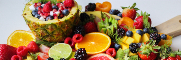 A display of fruits including berries and citruses.
