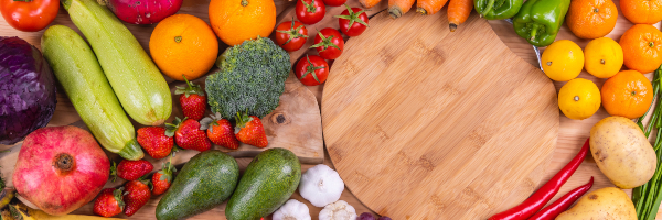 Nutrient rich food including oranges, strawberries, peppers, garlic and other vegetables.