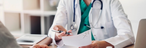 Doctor sat with a patient.