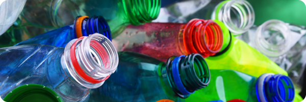 Different coloured plastic water bottles made from Bisphenol A (BPA) to represent that Bisphenol A can impact the gut microbiome. 