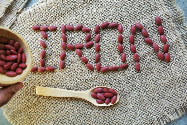 The word 'iron' spelled out in red kidney beans.