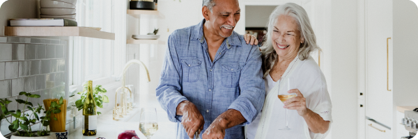 A couple cooking a meal together at home.