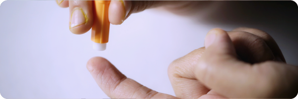 A person testing their vitamin D levels with a finger prick test. 