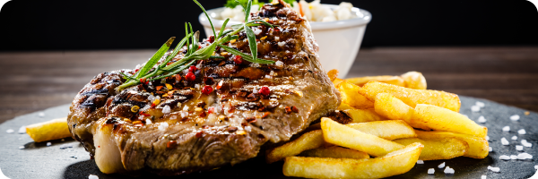 Steak and chips on a plate to convey that a diet low in dietary fibre can disrupt the gut microbiome. 