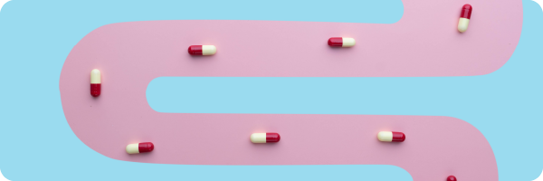 Medical pills lying on an illustration of a pink tube. Medication, especially antibiotics, PPIs and NSAIDs can disrupt the gut microbiome. 