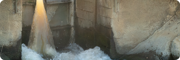 Water bursting through a dam opening to illustrate pressure and stress, which can affect the gut microbiome. 