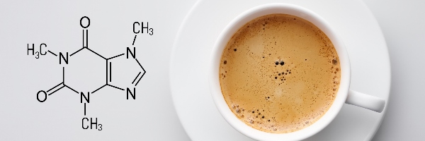 Chemical formula for caffeine next to a cup of coffee.