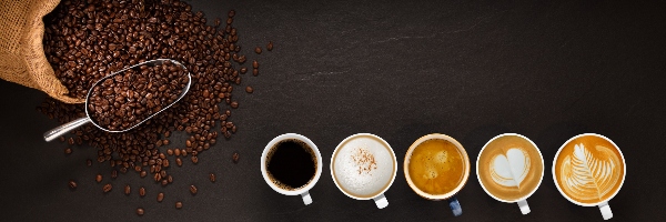 Variety of cups of coffee and coffee beans in burlap sack on black background.