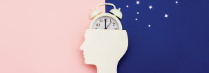 The shape of a human head with a clock coming out of the top to represent the body clock with half the image's background light and half the image's background like the dark blue with stars like night sky to represent the rhythms of light and dark which impact circadian rhythms.