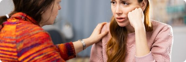 Woman comforting a friend experiencing depression.