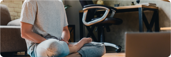 Meditation can help you sleep better. Image shows a man in a meditative pose sitting on the ground.