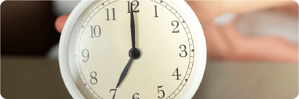 Stick to a routine for better sleep. Image shows a clock which displays the time as 7 o clock.
