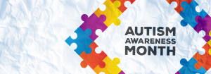 The words: 'Autism Awareness Month' surrounded by a diamond shape of different coloured jigsaw pieces.