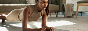 A person at home doing a plank fitness test.