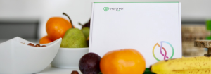 A photo of the Evergreen Life testing kit propped up with fruit on the table.