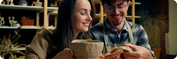 A couple engaging in creative therapies like clay pottery making.
