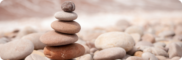 Balancing pebbles to represent mindfulness and meditation.